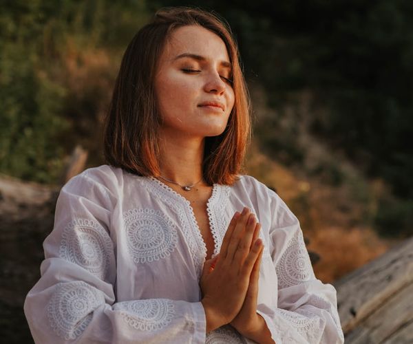 Person meditating in a calm environment, representing peace of mind.