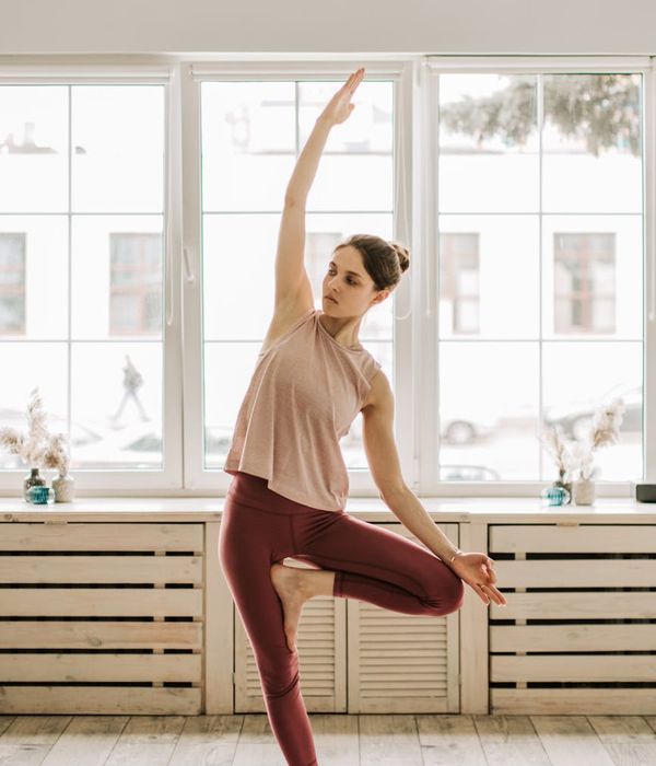 Woman in a graceful yoga pose, demonstrating flexibility and balance.